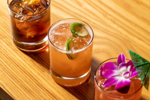 Lineup of cocktails on a wooden surface